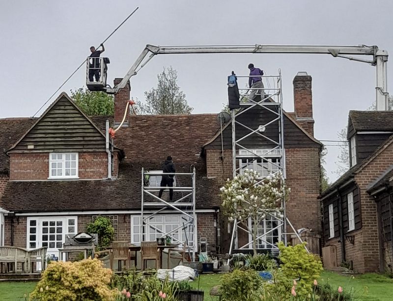 The Roof Moss Cleaners using cherry picker and scaffolding to clean roof safely and professionally in Windsor, Berkshire