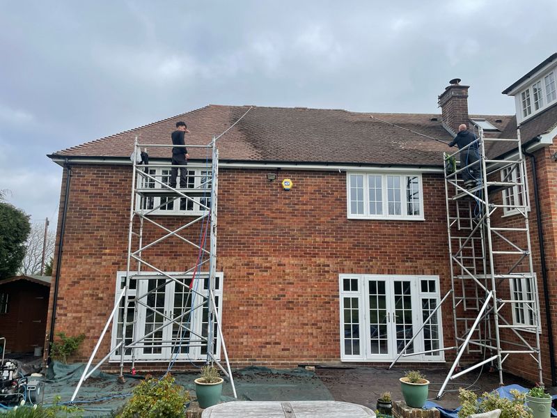 Roof cleaning carried out safely from scaffold towers by The Roof Moss Cleaners in Windsor